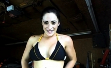 A teen girl flashing in garage in front of workers