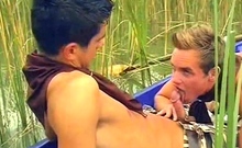 Hot boys rowing in a boat and sucking